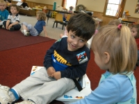 Samuel Habib, 3, sits in his supportive corner chair and smiles at a friend at Shaker Road School in Concord when he was a pre-schooler.  Samuel, now 7, has cerebral palsy.  His parents, Dan Habib and Betsy McNamara are committed to full inclusion for Samuel in the community, family and at school.    Dan Habib photo