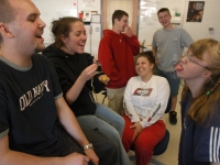 At times, there is a fine line between classmates laughing with or at Alana.  As a class winds down, students blow bubbles and Alana tries to catch them on her tongue, as classmates look on and laugh.   Dan Habib photo